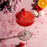 Raspberry martini in green martini glass.