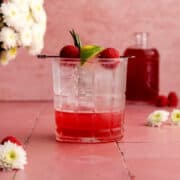 Raspberry mocktail in a double old-fashioned glass.