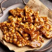 Orasnice - walnut brittle in a metal tray on parchment paper.