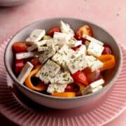 Serbian shopska salad in a small bowl.