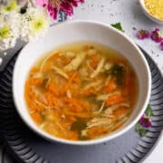 Hearty chicken soup in a small bowl.