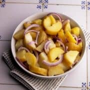Potato salad with onion in a bowl.