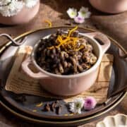 Sweet poppy seed pasta with spices and flowers on a tray.