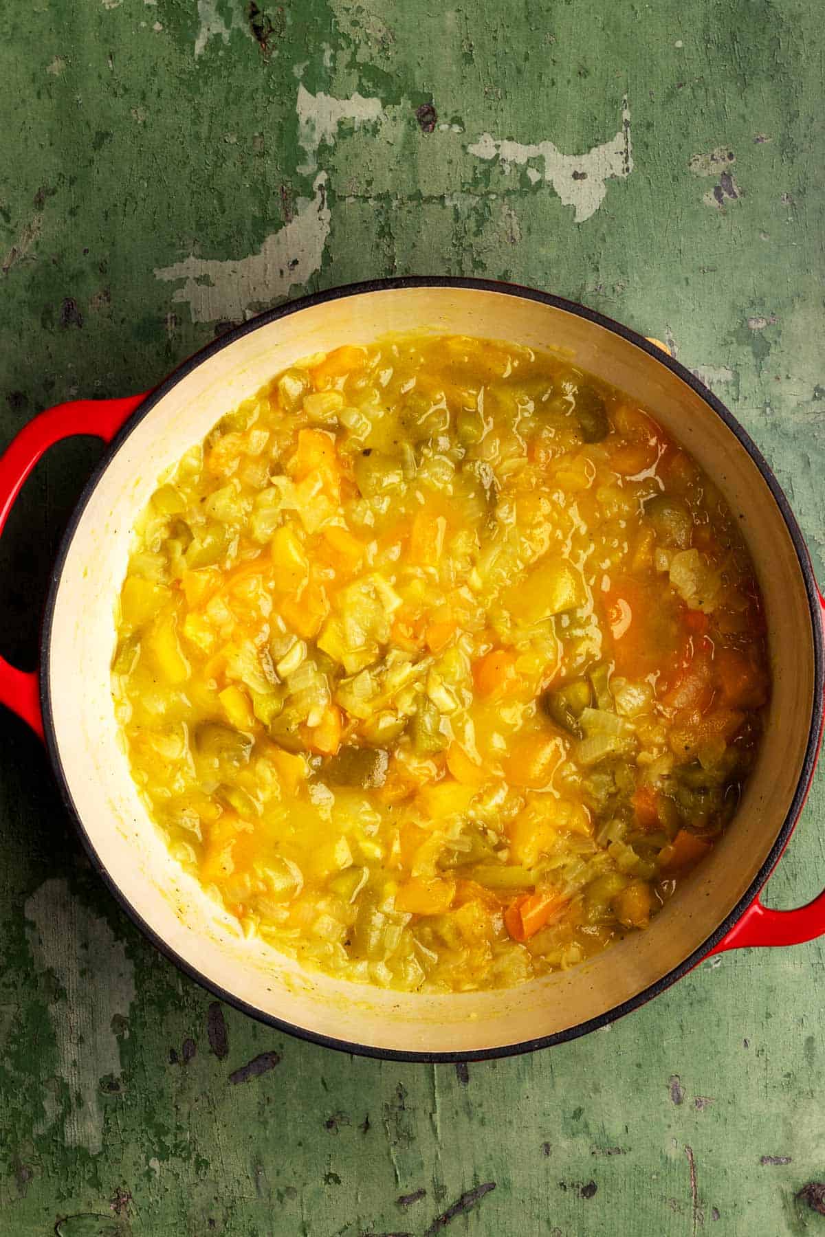 Cooked bell peppers and onion in a Dutch oven.