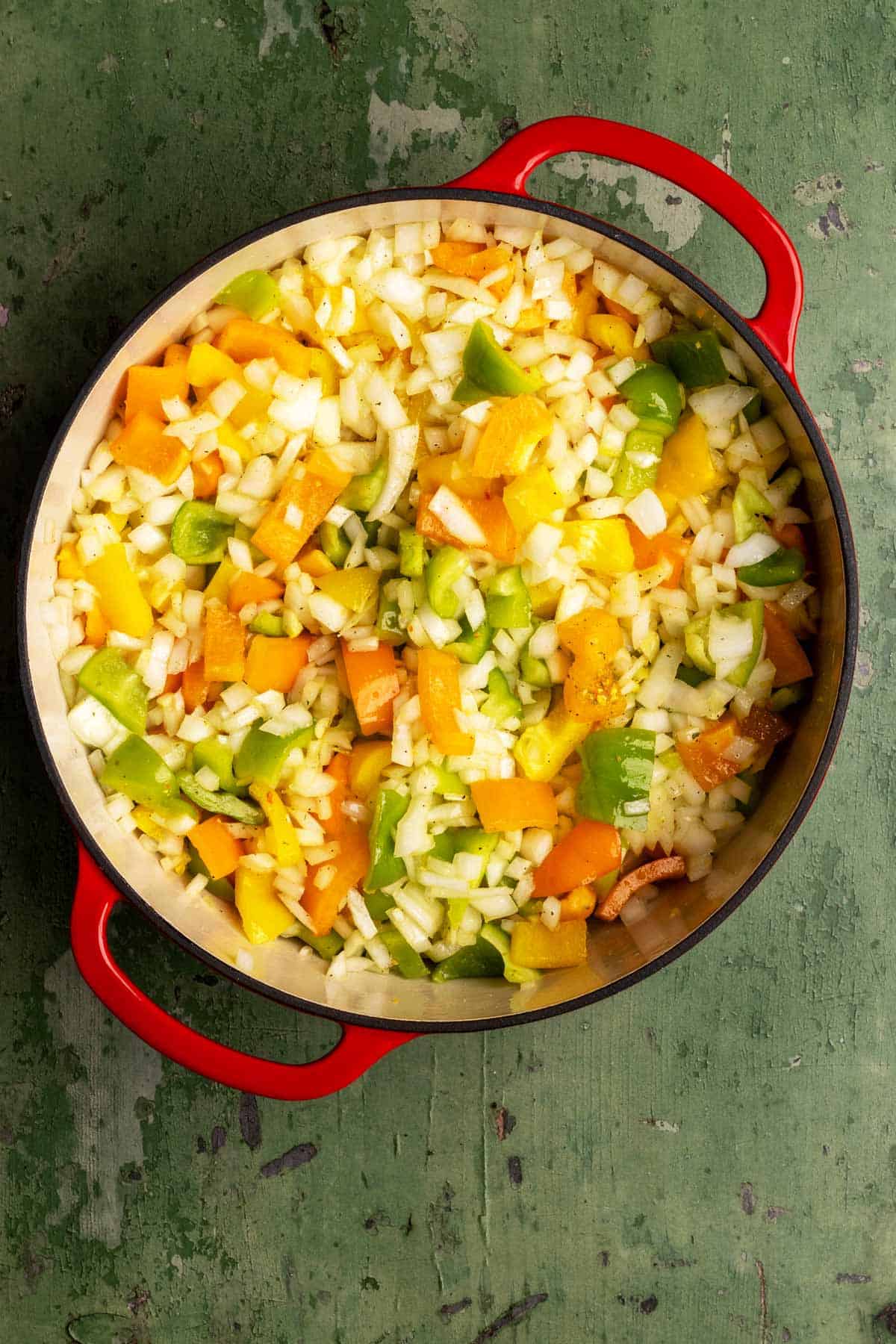 Chopped veggies and seasoning in a large Dutch oven.